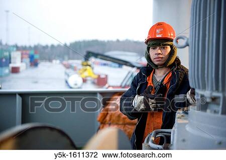 An Indonesian seaman or sailor on the container-vessel MV Flintercape, during a journey from Rotterdam, Netherlands, to Sundsvall, Sweden. The man is an ´Able Seaman´, who generally works on deck, and is now busy with meering the ship to the dock. View Large Photo Image Stock Image - An Indonesian seaman or sailor on the container-vessel MV Flintercape, during a journey from Rotterdam, Netherlands, to Sundsvall, Sweden. The man is an ´Able Seaman´, who generally works on deck, and is now busy with meering the ship to the dock.. Fotosearch