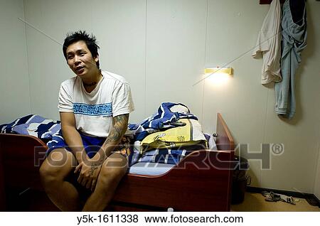 An Indonesian Seaman or sailor, waking up in his cabin on the container-vessel MV Flintercape, during a journey from Rotterdam, Netherlands, to Sundsvall, Sweden. The man is an ´Able Seaman´, who generally works on deck. View Large Photo Image Stock Photo - An Indonesian Seaman or sailor, waking up in his cabin on the container-vessel MV Flintercape, during a journey from Rotterdam, Netherlands, to Sundsvall, Sweden. The man is an ´Able Seaman´, who generally works on deck.. Fotosearch