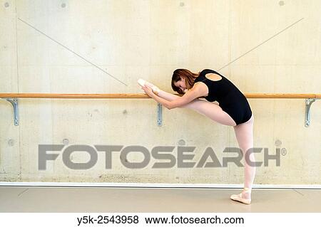 Stock Photo - Arnhem, Netherlands. Young brunette ballet dancer training and rehearsing classical ballet in her ballet studio.. Fotosearch