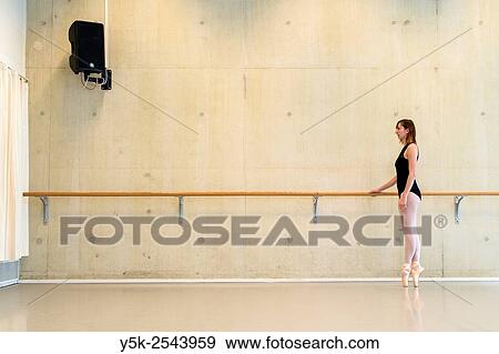 Arnhem, Netherlands. Young brunette ballet dancer training and rehearsing classical ballet in her ballet studio. View Large Photo Image Stock Photo - Arnhem, Netherlands. Young brunette ballet dancer training and rehearsing classical ballet in her ballet studio.. Fotosearch