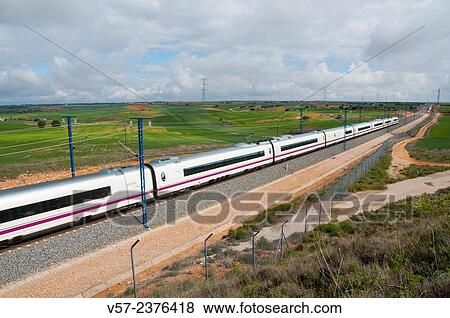 AVE high-speed train travelling along La Alcarria. Guadalajara province, Castilla La Mancha, Spain. View Large Photo Image Stock Photo - AVE high-speed train travelling along La Alcarria. Guadalajara province, Castilla La Mancha, Spain.. Fotosearch