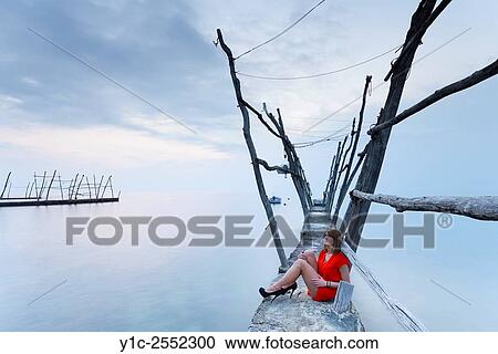 Stock Image - Beautiful teen girl in Red dress Savudria Croatia. Fotosearch