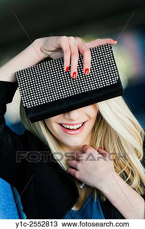 Stock Image - Beautiful young woman hiding eyes portrait. Fotosearch