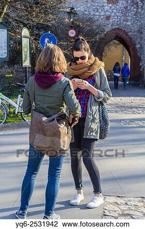 Stock Image - Beautiful., young woman smiling in the streets of Krakow, Poland, Europe.. Fotosearch