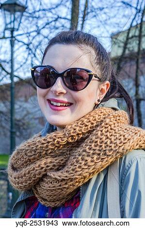 Stock Image - Beautiful., young woman smiling in the streets of Krakow, Poland, Europe.. Fotosearch