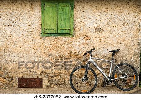 Stock Image - Bicycle and weathered wall, Northern Velebit National Park, Croatia.. Fotosearch