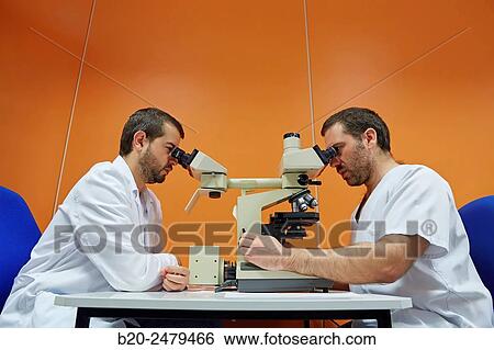 Stock Photograph - Binocular microscope heads for multiple viewing, Anatomic Pathology, Hospital Donostia, San Sebastian, Gipuzkoa, Basque Country, Spain. Fotosearch