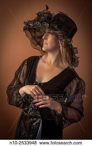 Stock Photo - Blond woman wearing a costume and hat.. Fotosearch