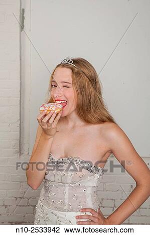 Blonde teenage girl eating a donut. View Large Photo Image Stock Image - Blonde teenage girl eating a donut.. Fotosearch