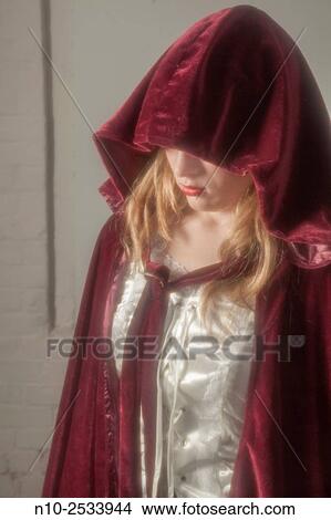 Blonde teenage girl wearing a robe with a hood. View Large Photo Image Picture - Blonde teenage girl wearing a robe with a hood.. Fotosearch