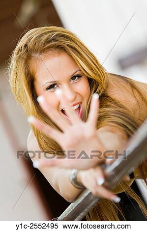 Blonde young woman watching hails View Large Photo Image Stock Photography - Blonde young woman watching hails. Fotosearch