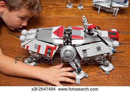 Boy age 8 playing with his Lego war fighting machine. St Paul Minnesota MN USA. View Large Photo Image Picture - Boy age 8 playing with his Lego war fighting machine. St Paul Minnesota MN USA.. Fotosearch