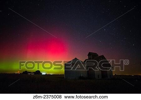 Stock Photo - Bright red auroras dance over Iowa during a short but intense outburst of northern lights.. Fotosearch