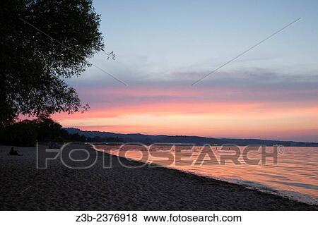 Brilliant pink sunset in summer on Lake Michigan in Traverse City, Michigan, MI, USA. View Large Photo Image Stock Photo - Brilliant pink sunset in summer on Lake Michigan in Traverse City, Michigan, MI, USA.. Fotosearch