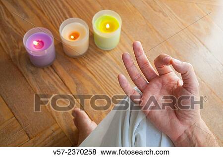 Close view of a man's hand practising yoga, sitting in the lotus position. View Large Photo Image Stock Photo - Close view of a man's hand practising yoga, sitting in the lotus position.. Fotosearch