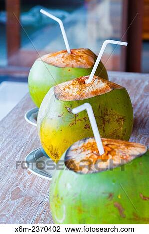 Stock Image - Coconuts on a table. Ubud. Bali. Indonesia, Asia.. Fotosearch