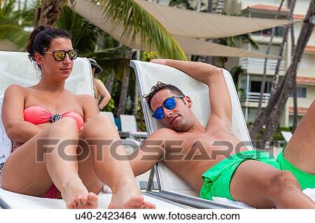 Picture - Couple sunbathing, Juan Dolio, Dominican Republic. Fotosearch
