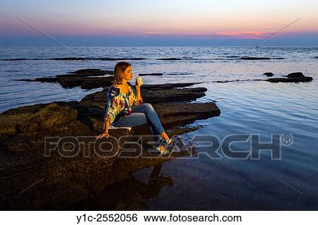 Stock Photograph - Cup of coffee sunset teenager girl.. Fotosearch