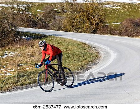 Stock Photo - cyclist on a road. Lizarraga pass. Navarre, Spain.. Fotosearch