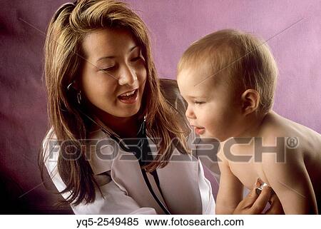 Stock Photography - doctor examining child patient.. Fotosearch
