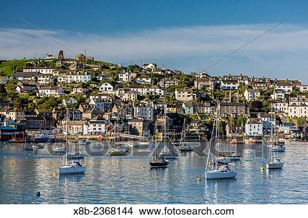 Early morning light on small boats at anchor in the harbor at Fohey, Foy, Cornwall, England. View Large Photo Image Picture - Early morning light on small boats at anchor in the harbor at Fohey, Foy, Cornwall, England.. Fotosearch