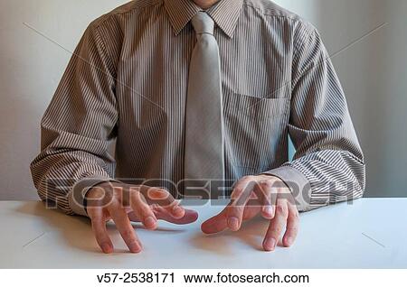 Stock Image - Executive´s hands drumming on the table. Close view.. Fotosearch