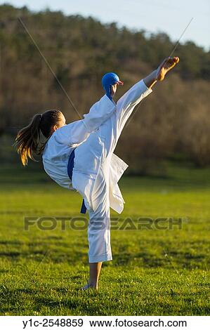 Stock Photo - Exercising karate kick teen girl. Fotosearch
