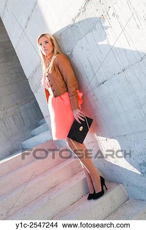 Picture - Fanciful young woman in Orange-Red dress. Fotosearch