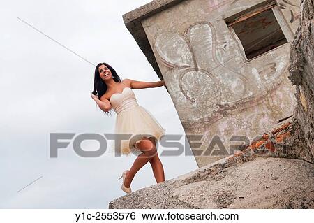 Fashionable teenager girl on elevated place against sky View Large Photo Image Stock Photograph - Fashionable teenager girl on elevated place against sky. Fotosearch