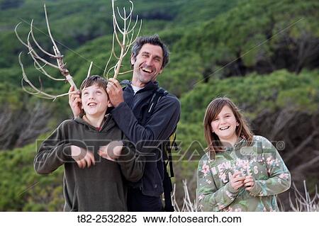 father and two children imitating deer antlers with a twig. Cadiz, Andalusia, Spain, Europe View Large Photo Image Stock Photography - father and two children imitating deer antlers with a twig. Cadiz, Andalusia, Spain, Europe. Fotosearch