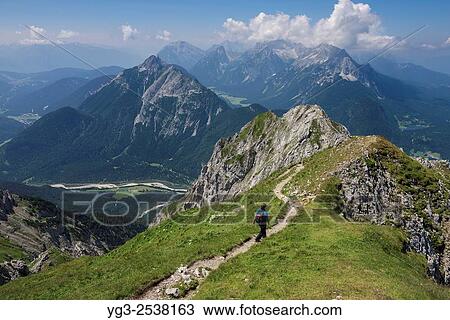 Female hiker on section of Mittenwalder Höhenweg in Karwendel mountains, Mittenwald, Bavaria, Germany. View Large Photo Image Stock Image - Female hiker on section of Mittenwalder Höhenweg in Karwendel mountains, Mittenwald, Bavaria, Germany.. Fotosearch