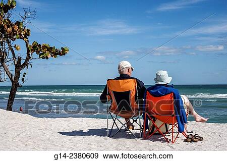 Florida, Stuart, Hutchinson Island, Bathtub Reef Beach, senior, man, woman, couple, sitting, chairs, sand dune, Atlantic Ocean View Large Photo Image Stock Photo - Florida, Stuart, Hutchinson Island, Bathtub Reef Beach, senior, man, woman, couple, sitting, chairs, sand dune, Atlantic Ocean. Fotosearch