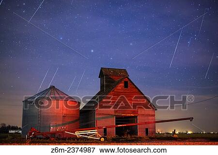 Geminid meteors streak across the sky behind a barn in western Iowa. View Large Photo Image Stock Photo - Geminid meteors streak across the sky behind a barn in western Iowa.. Fotosearch