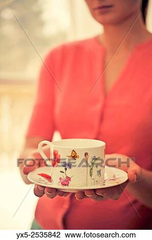 Girl holding a tea cup in her hands. View Large Photo Image Stock Image - Girl holding a tea cup in her hands.. Fotosearch