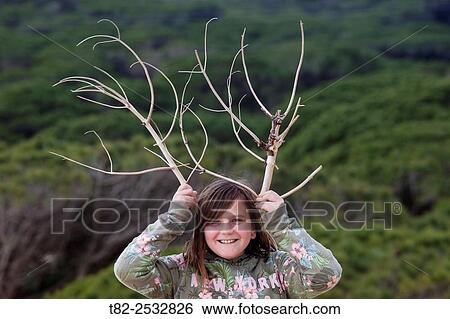 girl with wooden horns imitating deer antlers with a twig. Cadiz, Andalusia, Spain, Europe View Large Photo Image Stock Photograph - girl with wooden horns imitating deer antlers with a twig. Cadiz, Andalusia, Spain, Europe. Fotosearch