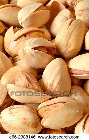 Stock Photograph - Healthy snacks: bowl of unsalted pistachio nuts. Close up.. Fotosearch