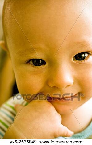 infant boy with a finger in his mouth. View Large Photo Image Stock Photo - infant boy with a finger in his mouth.. Fotosearch