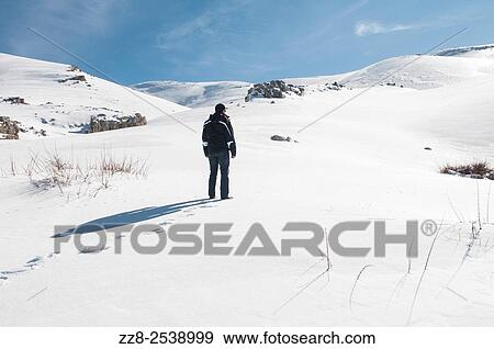 Stock Photo - Man standing in the snow Faraya Lebanon. Fotosearch