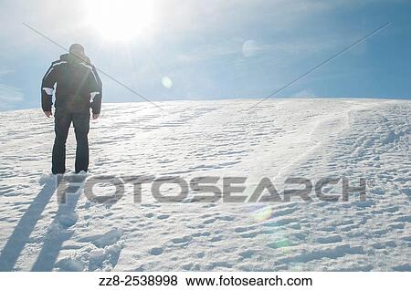 Stock Photo - Man walking in the snow Faraya Lebanon. Fotosearch