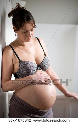 Middel-aged woman, expecting her first child, after being pregnant for 38 weeks. View Large Photo Image Stock Image - Middel-aged woman, expecting her first child, after being pregnant for 38 weeks.. Fotosearch