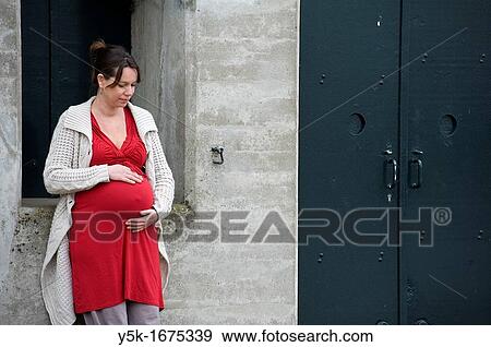 Stock Photo - Middel-aged woman, expecting her first child, after being pregnant for 38 weeks.. Fotosearch