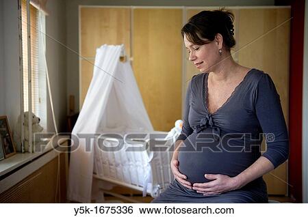 Middel-aged woman, expecting her first child, after being pregnant for 38 weeks. View Large Photo Image Stock Photograph - Middel-aged woman, expecting her first child, after being pregnant for 38 weeks.. Fotosearch