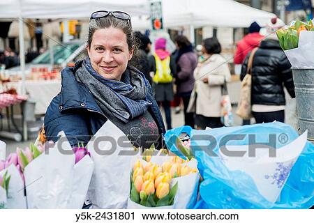 New York, USA. Dark blonde woman buying flowers at a market stall on Union Square, Manhattan. View Large Photo Image Stock Image - New York, USA. Dark blonde woman buying flowers at a market stall on Union Square, Manhattan.. Fotosearch