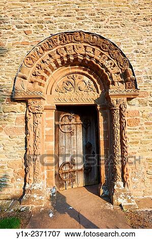 Stock Photo - Norman Romanesque relief sculptures of dragons and mythical creatures depicting the struggle between good and evil, from the South doorway of Church of St Mary and St David, Kilpeck Herifordshire, England. Built around 1140.. Fotosearch