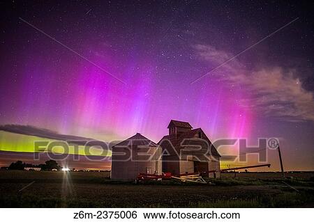 Stock Photograph - Nothern lights dance above the Iowa landscape.. Fotosearch