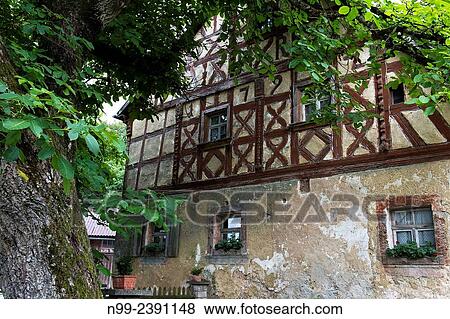 Stock Photo - Old framework house from 1792, baroque style, walnut tree, Franconian village, Bavaria, Germany.. Fotosearch