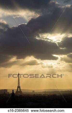 Stock Photography - Paris, France - city skyline dominated by Eiffel Tower seen from a Montmartre rooftop, with a gloomy winter sunset sky as background. Fotosearch