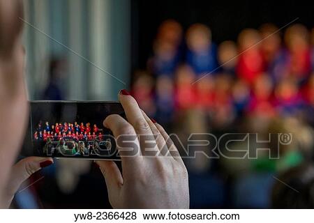 Stock Photo - People taking pictures of children performing at the Idno Theater, Annual Children's Festival, Reykjavik, Iceland.. Fotosearch