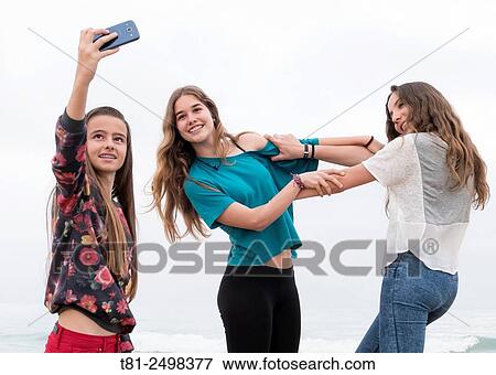 Playful young girls making selfies. Valencia, Spain View Large Photo Image Stock Photo - Playful young girls making selfies. Valencia, Spain. Fotosearch