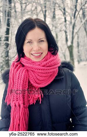 Stock Photography - Portrait of a smiling mid adult woman, winter. Fotosearch
